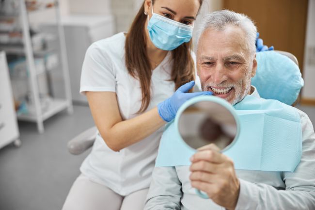 man smiling in dentists chair